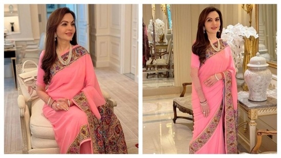 Nita Ambani looked graceful in this lotus pink custom Manish Malhotra Saree. The layered pearl necklace complemented her outfit well. The saree featured hand-crafted kalamkari. She wore it to the inaugration of India House at the Paris Olympics 2024.(Instagram/@manishmalhotra05)