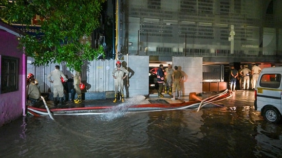 Officials from Fire Department pumps out the water from Rau' IAS study circle in old Rajendra Nagar where few students were allegedly drowned to death after the basement of the building was flooded following heavy rain in New Delhi, (Hindustan Times)