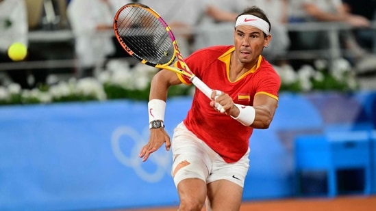 Spain's Rafael Nadal playing with Spain's Carlos Alcaraz returns to Argentina's Maximo Gonzalez and Argentina's Andres Molteni during their men's doubles first round tennis match(AFP) Spain's Rafael Nadal playing with Spain's Carlos Alcaraz returns to Argentina's Maximo Gonzalez and Argentina's Andres Molteni during their men's doubles first round tennis match(AFP)