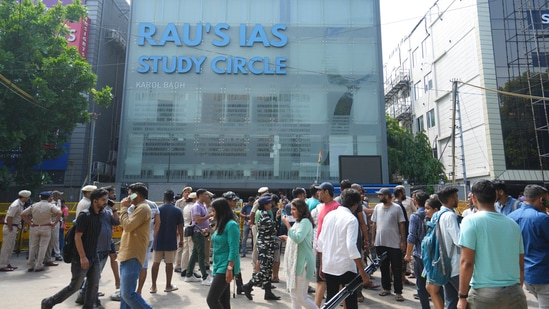 Security personnel stand guard near a UPSC exam coaching centre after three civil services aspirants died when the basement of the coaching centre was flooded by rainwater, in New Delhi, Sunday, July 28, 2024.(PTI)