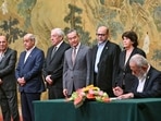 China's Foreign Minister Wang Yi, fourth left, looks on, while hosting an event of signing of the China's Foreign Minister Wang Yi, fourth left, looks on, while hosting an event of signing of the