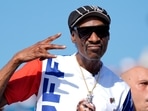 US artist Snoop Dogg gestures to the camera while attending the men's skateboard street final at the 2024 Summer Olympics, Monday, July 29, 2024, in Paris, France. (AP Photo/Frank Franklin II)