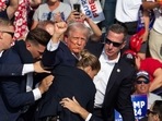 Republican candidate Donald Trump is seen with blood on his face surrounded by secret service agents as he is taken off the stage at a campaign event at Butler Farm Show Inc. in Butler, Pennsylvania, July 13, 2024. Donald Trump was hit in the ear in an apparent assassination attempt by a gunman at a campaign rally on Saturday, (AFP)