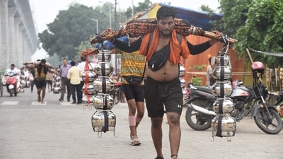 Kanwariyas carry holy water collected from Ganga River in Haridwar during Kanwar Yatra near Nandgram on Ghaziabad-Delhi-Meerut road. (Sakib Ali/HT)