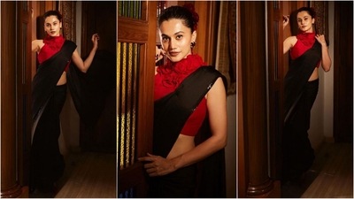 Taapsee Pannu is in her saree era, and we absolutely love it. Her latest look features a black saree with sequin borders. She paired it with a red sleeveless halter neck blouse adorned with rose embellishments, exuding sheer glamour. (Instagram) Taapsee Pannu is in her saree era, and we absolutely love it. Her latest look features a black saree with sequin borders. She paired it with a red sleeveless halter neck blouse adorned with rose embellishments, exuding sheer glamour. (Instagram)