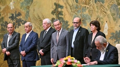 China's Foreign Minister Wang Yi, fourth left, looks on, while hosting an event of signing of the "Beijing declaration" between Palestinian factions, Fatah and Hamas, at the Diaoyutai State Guesthouse in Beijing, Tuesday, July 23, 2024. Mahmoud al-Aloul of Fatah, third left, and Mussa Abu Marzuk of Hamas, third right, are seen. AP/PTI(AP07_23_2024_000292B) (AP) China's Foreign Minister Wang Yi, fourth left, looks on, while hosting an event of signing of the "Beijing declaration" between Palestinian factions, Fatah and Hamas, at the Diaoyutai State Guesthouse in Beijing, Tuesday, July 23, 2024. Mahmoud al-Aloul of Fatah, third left, and Mussa Abu Marzuk of Hamas, third right, are seen. AP/PTI(AP07_23_2024_000292B) (AP)
