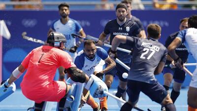 India midfielder Sukhjeet Singh (C) in action with the Argentina goalkeeper Tomas Santiago trying to block an attempt in the men’s hockey Group B match in Paris on Monday. (REUTERS) India midfielder Sukhjeet Singh (C) in action with the Argentina goalkeeper Tomas Santiago trying to block an attempt in the men’s hockey Group B match in Paris on Monday. (REUTERS)