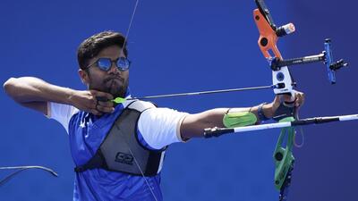 India’s Dhiraj Bommadevara shoots during the men’s team quarter-final against Turkey on Monday. (AP) India’s Dhiraj Bommadevara shoots during the men’s team quarter-final against Turkey on Monday. (AP)