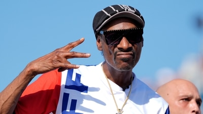 US artist Snoop Dogg gestures to the camera while attending the men's skateboard street final at the 2024 Summer Olympics, Monday, July 29, 2024, in Paris, France. (AP Photo/Frank Franklin II) (AP) US artist Snoop Dogg gestures to the camera while attending the men's skateboard street final at the 2024 Summer Olympics, Monday, July 29, 2024, in Paris, France. (AP Photo/Frank Franklin II) (AP)