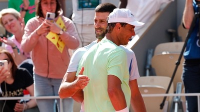 Serbia's Novak Djokovic hugs Spain's Rafael Nadal during a practice session. (REUTERS)