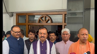 Uttar Pradesh CM Yogi Adityanath with his deputies Brajesh Pathak and Keshav Prasad Maurya addresses the media during the Monsoon session of UP Assembly (PTI)