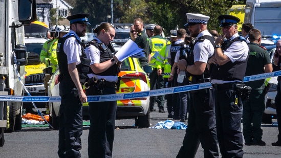 Police secure the area, where a man has been detained and a knife has been seized after a number of people were injured in a reported stabbing, in Southport, Merseyside. (AP)