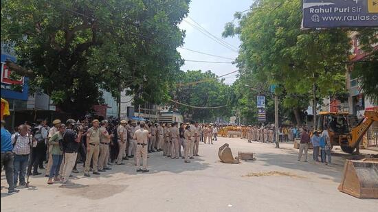 Bulldozers razing illegal encroachments at Delhi’s Rajendra Nagar where three students allegedly drowned in a flooded basement on Saturday night. (HT Photo)