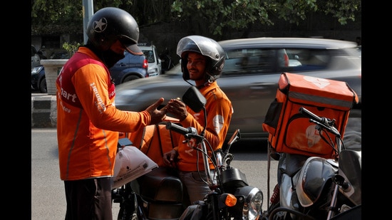 Gig workers prepare to deliver orders outside Swiggy's grocery warehouse at a market area in New Delhi, India, May 6, 2024. REUTERS/Priyanshu Singh (REUTERS)