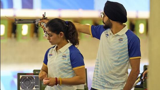 India's Manu Bhaker, left, and teammate Sarabjot Singh compete in the 10m air pistol mixed team qualification round at the Paris Olympics on Monday. (AP)