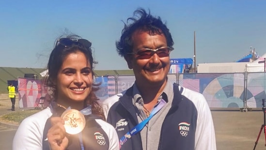 India's Manu Bhaker with her coach Jaspal Rana after winning a Bronze Medal in the 10m Air Pistol Women's Final event at the Summer Olympics 2024, in Chateauroux, France, Sunday, July 28, 2024. (PTI)