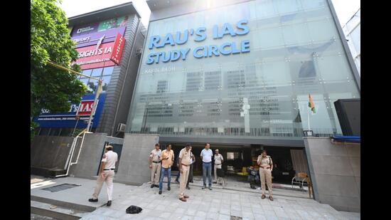 Police officers outside the Rau’s IAS Study circle in Delhi on Monday. (ArvindYadav/HT Photo)