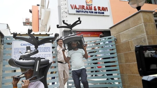 The staff of a coaching centre vacate their basement in Old Rajendra Nagar in New Delhi on Monday. (Arvind Yadav/HT Photo)