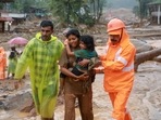 Rescuers help residents to move to a safer place, at a landslide site after multiple landslides in the hills, in Wayanad, Kerala, on July 30, 2024. 