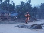 Members of rescue teams conduct rescue operation at a landslide site after multiple landslides in the hills in Wayanad,