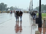 Visitors enjoy light rain at Kartavya Path, in New Delhi. (Photo by Sanjeev Verma/ Hindustan Times) Visitors enjoy light rain at Kartavya Path, in New Delhi. (Photo by Sanjeev Verma/ Hindustan Times)