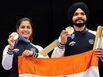 Shooters Manu Bhaker and Sarabjot Singh pose for a photograph with the national flag on winning the Bronze medal in the 10m Air Pistol Mixed Team event at the Olympic Games Paris 2024, in Paris on Tuesday. (ANI) Shooters Manu Bhaker and Sarabjot Singh pose for a photograph with the national flag on winning the Bronze medal in the 10m Air Pistol Mixed Team event at the Olympic Games Paris 2024, in Paris on Tuesday. (ANI)