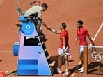Spain's Rafael Nadal (C) shakes hands with chair umpire Renaud Lichtenstein of France after his defeat to Serbia's Novak Djokovic (R) in their men's singles second round tennis match. Spain's Rafael Nadal (C) shakes hands with chair umpire Renaud Lichtenstein of France after his defeat to Serbia's Novak Djokovic (R) in their men's singles second round tennis match.