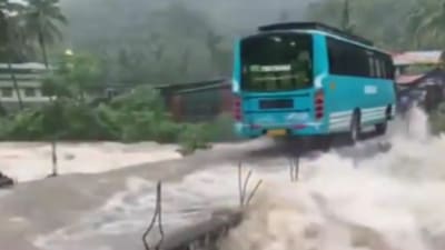 A bus crosses a bridge even as water rages around it in Kerala's Kozhikode. (X/@ANI)