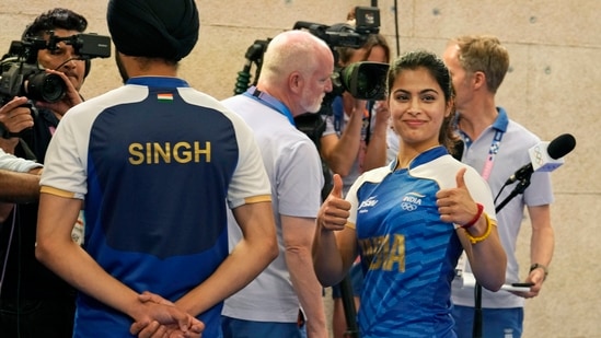 India's Sarabjot Singh, left, speaks with media personnel as Manu Bhaker gestures after the duo won the bronze medal in the 10m air pistol mixed team event at the 2024 Summer Olympics, Tuesday, July 30, 2024(AP)