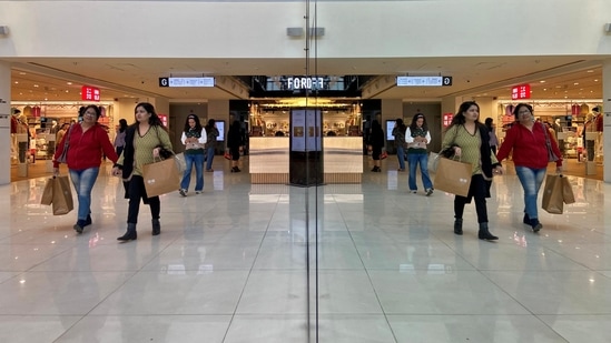 FILE PHOTO: Shoppers are reflected in mirror inside a shopping mall in New Delhi, India, December 14, 2022. REUTERS/Anushree Fadnavis/File Photo(REUTERS)