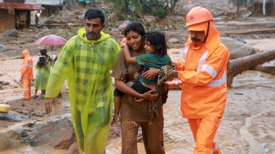 Rescuers help residents to move to a safer place, at a landslide site after multiple landslides in the hills, in Wayanad, Kerala, on July 30, 2024. (REUTERS)