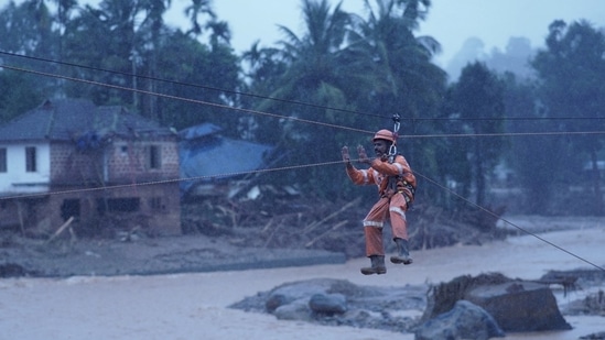 Members of rescue teams conduct rescue operation at a landslide site after multiple landslides in the hills in Wayanad,(Reuters)