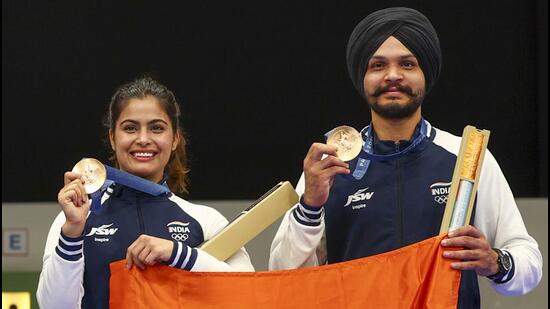 Bronze medalists Manu Bhaker and Sarabjot Singh pose during the medal ceremony for the 10m Air Pistol Mixed Team event, on Tuesday. (EPA-EFE)