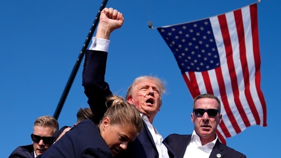 Trump rally shooting: Horrifying new clip shows cops with guns surrounding building (AP Photo/Evan Vucci, File)(AP)