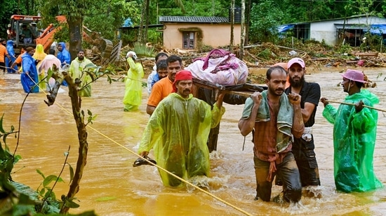 Relief personnel carry the body of a victim, during a search and rescue operation at a site following landslides in Wayanad on July 30, 2024. (Photo by R. J. Mathew / AFP)(AFP)