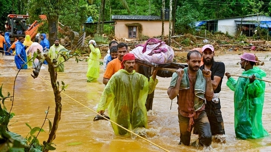 Relief personnel carry the body of a victim, during a search and rescue operation at a site following landslides in Wayanad on July 30, 2024. (Photo by R. J. Mathew / AFP)(AFP)