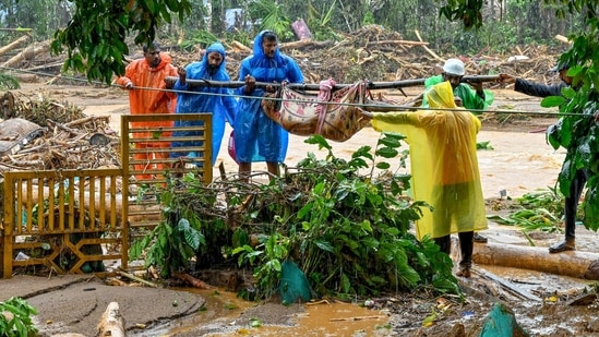 Relief personnel carry the body of a victim, during a search and rescue operation at a site following landslides in Wayanad on July 30, 2024. (Photo by R. J. Mathew / AFP)(AFP)