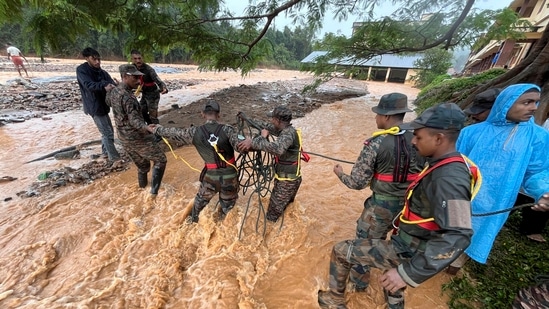 This photograph provided by PRO Defense Kochi shows Indian army soldiers engaged in rescue operations at landslide affected village in Wayanad.(AP)