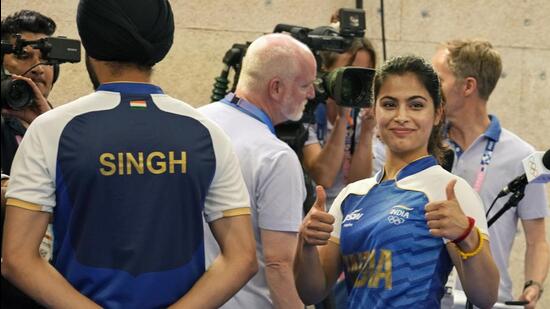India's Manu Bhaker celebrates after winning the bronze medal in the 10m air pistol mixed team event with Sarabjot Singh. (AP)