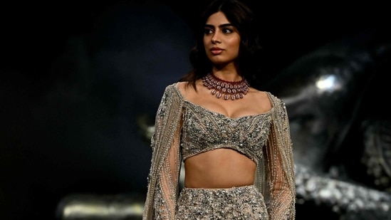 Actor Khushi Kapoor presents a creation by Indian fashion designer Gaurav Gupta during the FDCI India Couture Week.(AFP)