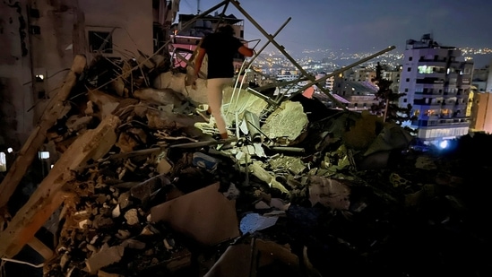 A man inspects a destroyed building that was hit by an Israeli airstrike in the southern suburbs of Beirut, Lebanon, Tuesday, July 30, 2024. (AP Photo/Hussein Malla)(AP)