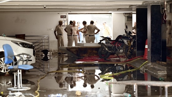 Delhi Police officers and MCD officials investigate Rau's IAS Study circle Spot at Old Rajinder Nagar area, after three civil services aspirants died at a coaching centre due to drowning, in in New Delhi, India, on Monday, July 29, 2024. (Photo by Arvind Yadav/ Hindustan Times) (Hindustan Times)