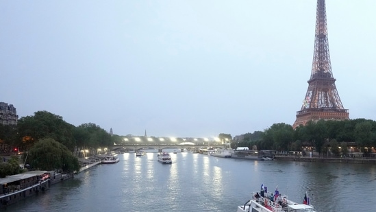 Team boats on the Siene with the Eiffel Tower in the background during the opening ceremony of the 2024 Summer Olympics in Paris, France, Friday, July 26, 2024(AP)