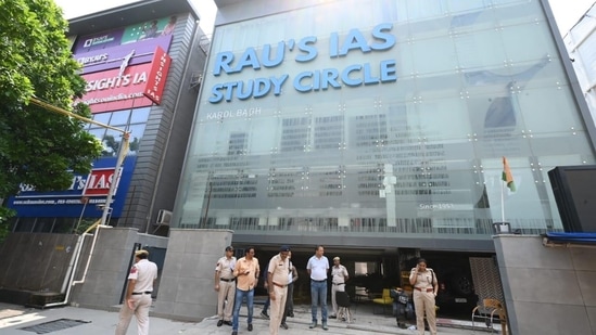 Police officers outside the Rau’s IAS Study circle in Delhi on Monday. (ArvindYadav/HT Photo)