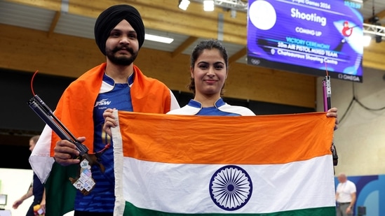 Bronze medalists India's Manu Bhaker and India's Sarabjot Singh pose at the end of the shooting 10m air pistol mixed team event during the Paris 2024 Olympic Games(AFP)
