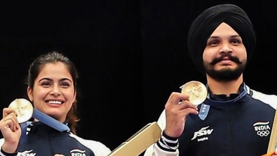 Shooters Manu Bhaker and Sarabjot Singh pose for a photograph with the national flag on winning the Bronze medal in the 10m Air Pistol Mixed Team event at the Olympic Games Paris 2024, in Paris on Tuesday. (ANI)