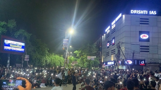 Students protest outsdie Drishti IAS coaching centre in North West Delhi's Mukherjee Nagar on Monday evening. (@AddarshK/X)