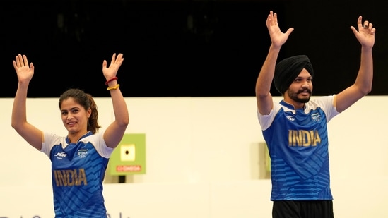India's Manu Bhaker (left) and Sarabjot Singh (right) celebrate after winning the bronze medal in the 10m air pistol mixed team event at the 2024 Summer Olympics, Tuesday.(AP)
