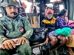 The Indian Army personnel rescue stranded people and carry them to safer places on helicopters during a search and rescue operation following a devastating landslide that hit hilly villages triggered by heavy rainfall. (ANI Photo) The Indian Army personnel rescue stranded people and carry them to safer places on helicopters during a search and rescue operation following a devastating landslide that hit hilly villages triggered by heavy rainfall. (ANI Photo)