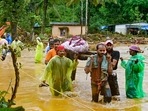 Relief personnel carry the body of a victim, during a search and rescue operation at a site following landslides in Wayanad.(AFP) Relief personnel carry the body of a victim, during a search and rescue operation at a site following landslides in Wayanad.(AFP)